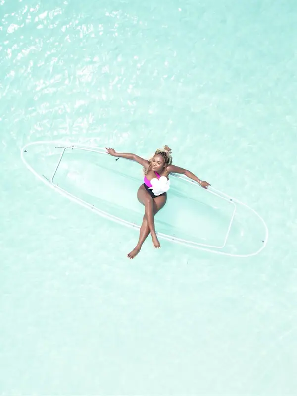 A see-through kayak on clear water