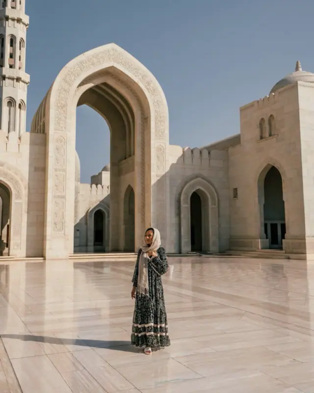 A traveller in the marble courtyard of the Sultan Qaboos Grand Mosque, Muscat