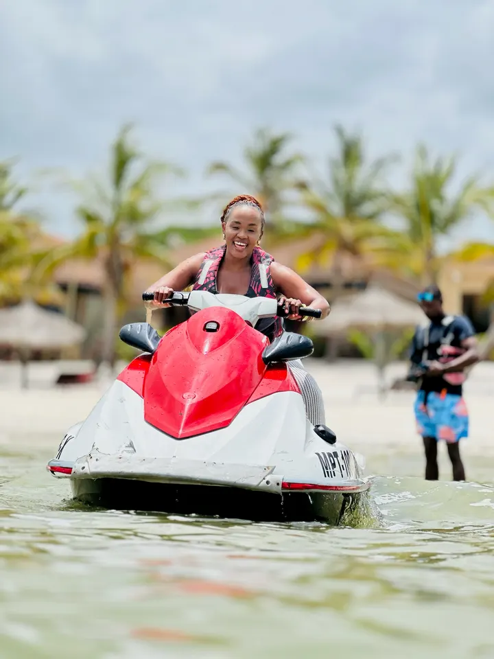A woman riding a jet ski at the beach