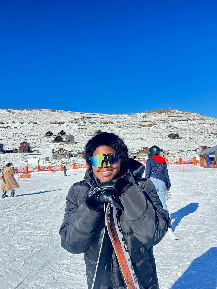 A traveller in ski goggles and a puffer jacket in the Lesotho snow